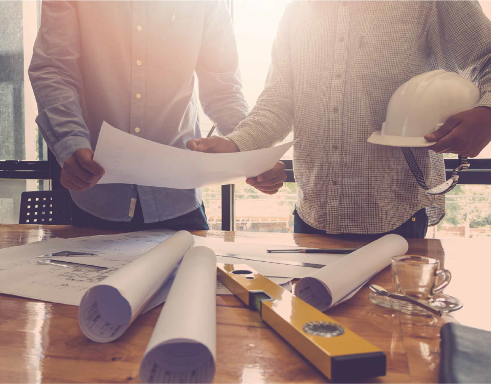 Hamilton home renovation permit documents and building plans on a desk