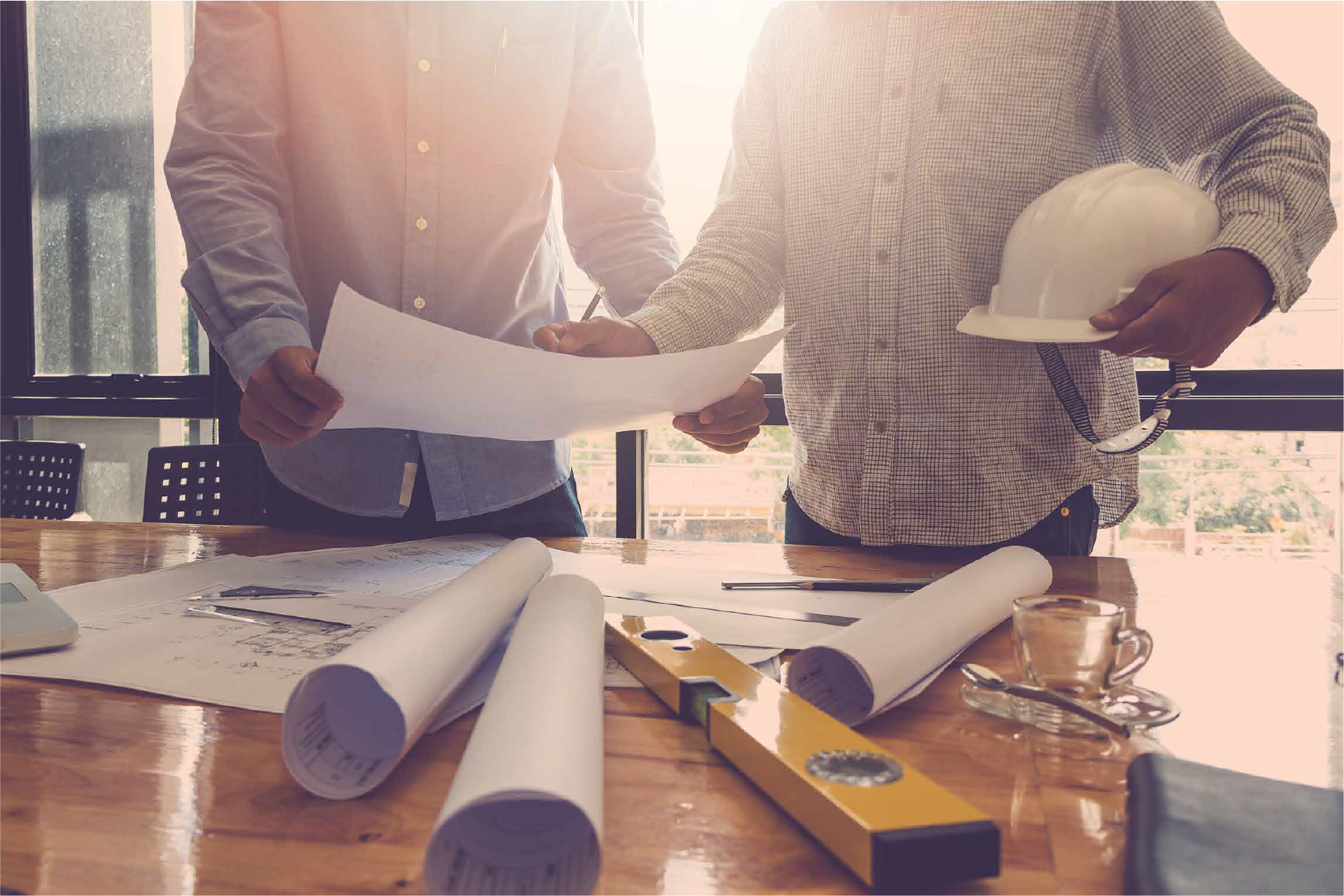 Hamilton home renovation permit documents and building plans on a desk