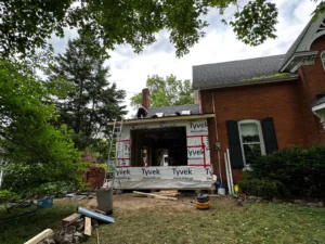 Gateway Group team measuring basement ceiling height during a property assessment in Hamilton — checking conversion feasibility before any construction commitment 