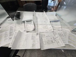 Gateway Group team conducting a property feasibility assessment at an older Hamilton home — reviewing lot dimensions and basement conditions before any conversion work begins 