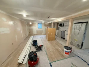 Before and after comparison of a Hamilton basement conversion — raw unfinished basement on the left, completed legal basement suite with separate entrance on the right, built by Gateway Group