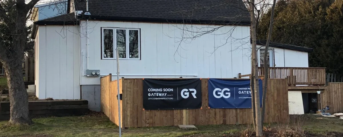 Hamilton homeowner standing in front of newly converted legal basement suite with Gateway Group signage