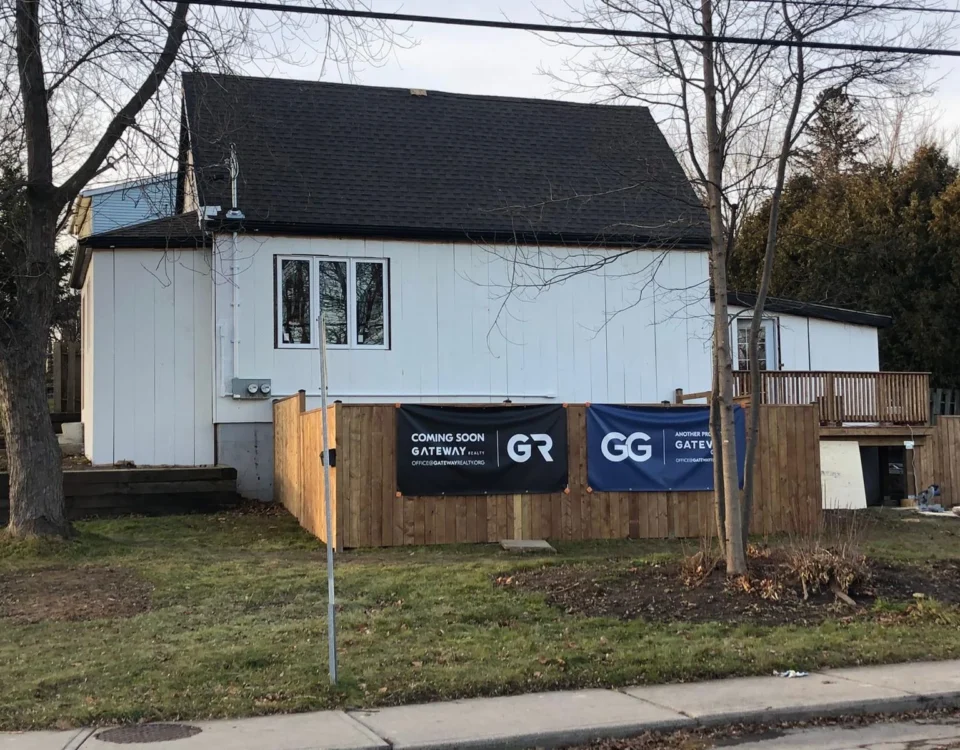 Hamilton homeowner standing in front of newly converted legal basement suite with Gateway Group signage