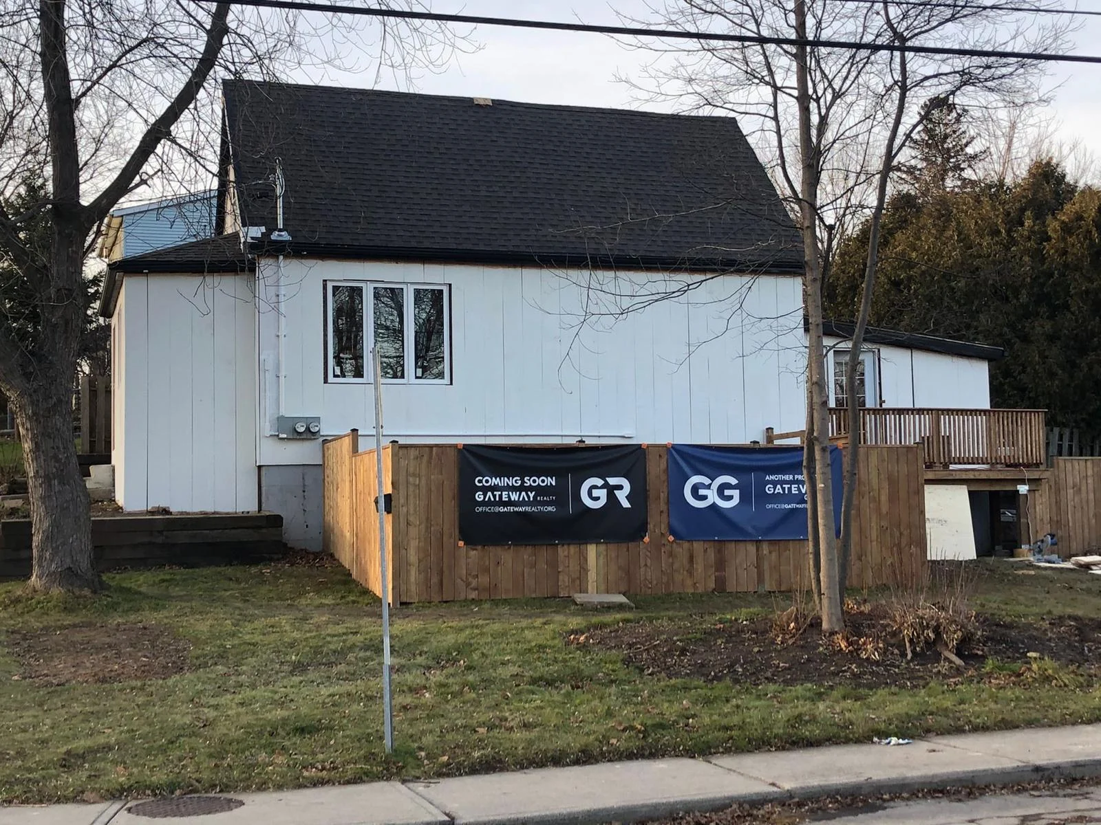 Hamilton homeowner standing in front of newly converted legal basement suite with Gateway Group signage
