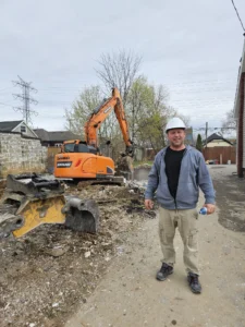 Gateway Group construction lead reviewing City of Hamilton building permit documentation on a basement suite conversion job site