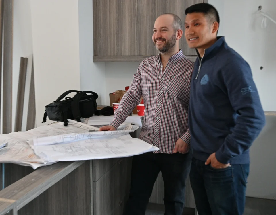 Property owner and contractor reviewing a renovation contract in Hamilton