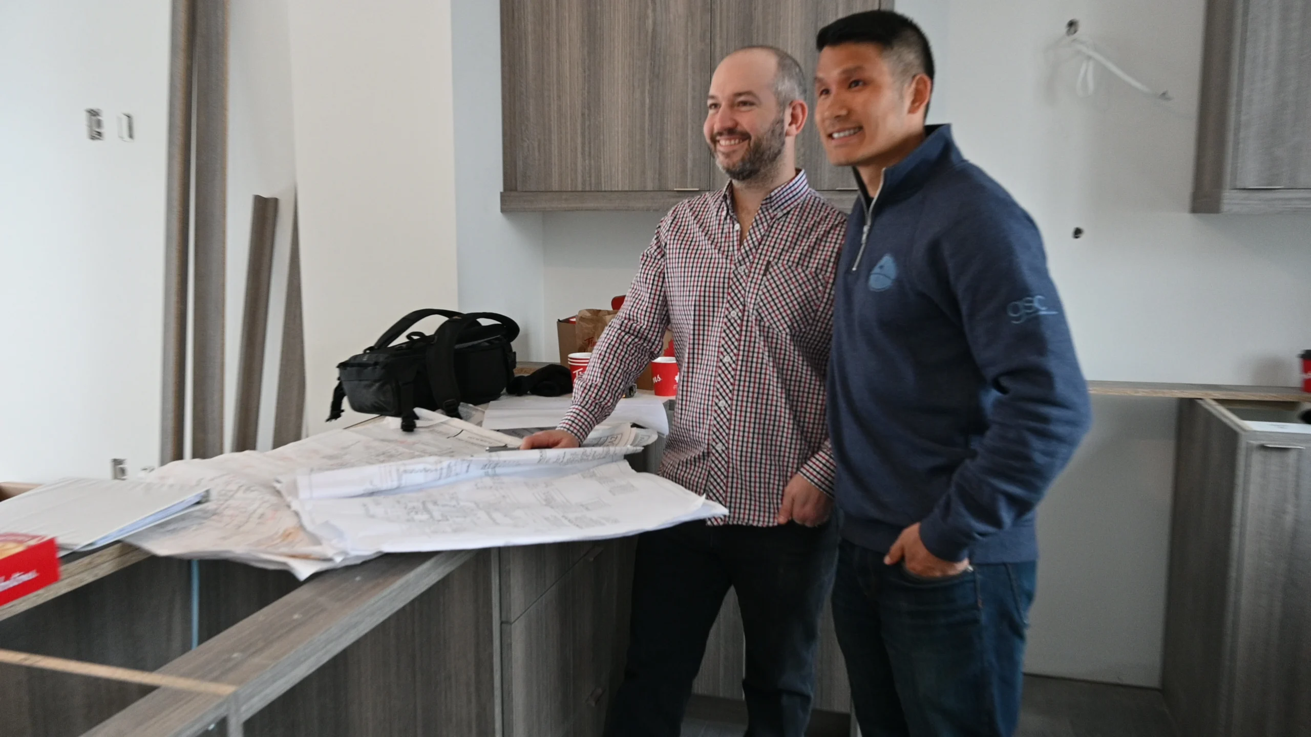 Property owner and contractor reviewing a renovation contract in Hamilton
